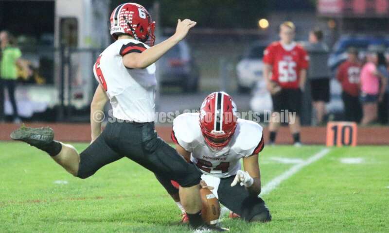 Madison High School's Korbin Kilbarger boots an extra point as Quincy Brown holds Oct. 3, 2019, during a Southwestern Buckeye League football game at Dixie. The visiting Mohawks won 48-13. RICK CASSANO/STAFF