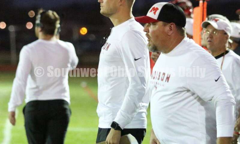 Madison High School head coach Ricky Davis (left) and assistant Steve Poff watch from the sideline Oct. 3, 2019, during a Southwestern Buckeye League football game at Dixie. The visiting Mohawks won 48-13. RICK CASSANO/STAFF