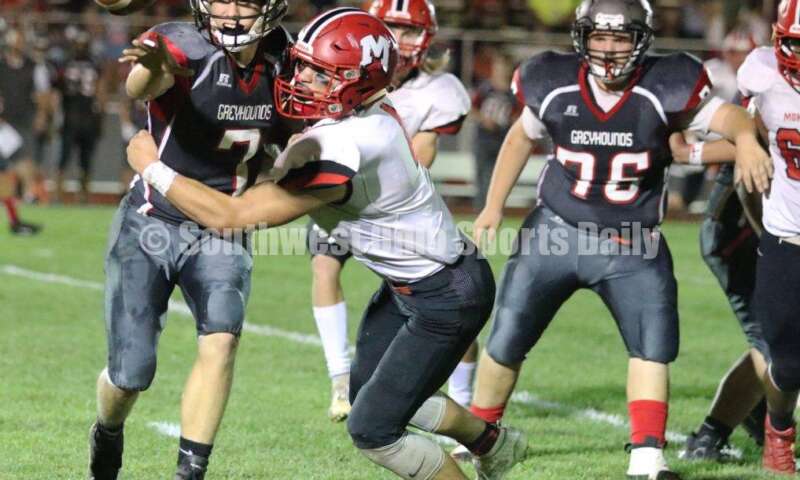 Madison High School's Devin Oligee hits Dixie quarterback Jimmy Myers (7) as he pitches the ball Oct. 3, 2019, during a Southwestern Buckeye League football game at Dixie. The visiting Mohawks won 48-13. RICK CASSANO/STAFF