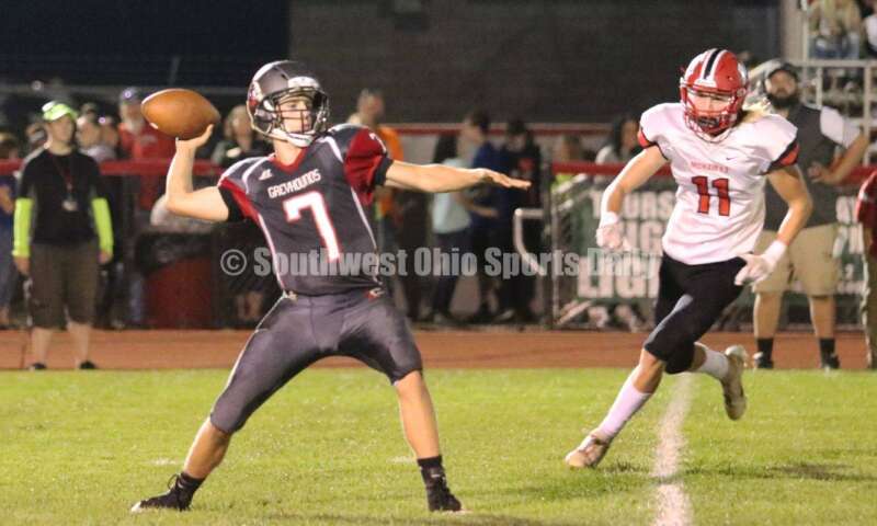 Madison High School's Evan Cox (11) rushes toward Dixie quarterback Jimmy Myers (7) on Oct. 3, 2019, during a Southwestern Buckeye League football game at Dixie. The visiting Mohawks won 48-13. RICK CASSANO/STAFF