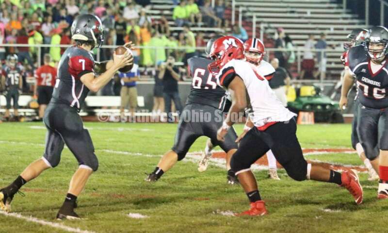 Madison High School's Tyler McCracken is about to hit Dixie quarterback Jimmy Myers (7) on Oct. 3, 2019, during a Southwestern Buckeye League football game at Dixie. The visiting Mohawks won 48-13. RICK CASSANO/STAFF