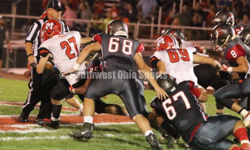 Madison High School's Gabe Higgs (27) gets through the Dixie defense Oct. 3, 2019, during a Southwestern Buckeye League football game at Dixie. The visiting Mohawks won 48-13. RICK CASSANO/STAFF