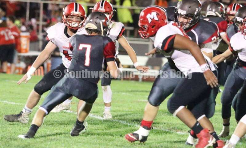 Madison HIgh School's Gavin Turner (44) eyes Dixie quarterback Jimmy Myers (7) on Oct. 3, 2019, during a Southwestern Buckeye League football game at Dixie. The visiting Mohawks won 48-13. RICK CASSANO/STAFF