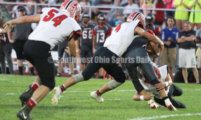 Madison High School's Devin Oligee (4) gets a firm grip on Dixie's Dustin Simon on Oct. 3, 2019, during a Southwestern Buckeye League football game at Dixie. The visiting Mohawks won 48-13. RICK CASSANO/STAFF