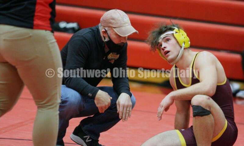 Ross High School's Sean Beltran talks with coach Rich Dunn while receiving some medical attention during a 152-pound contest against Blanchester's Gage Berwanger Jan. 13, 2021, in a dual wrestling match at New Richmond. RICK CASSANO/STAFF