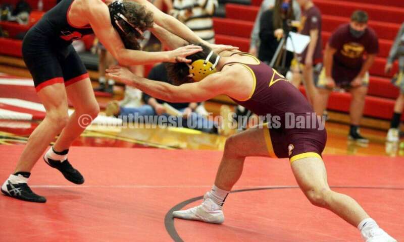Ross High School's Sean Beltran (right) goes after New Richmond's Griffin Ross at 152 pounds Jan. 13, 2021, during a dual wrestling match at New Richmond. RICK CASSANO/STAFF