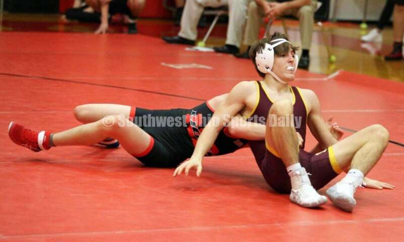 New Richmond High School's Derrick Klinker gets a grasp on Ryan Foster of Ross at 132 pounds Jan. 13, 2021, during a dual wrestling match at New Richmond. RICK CASSANO/STAFF