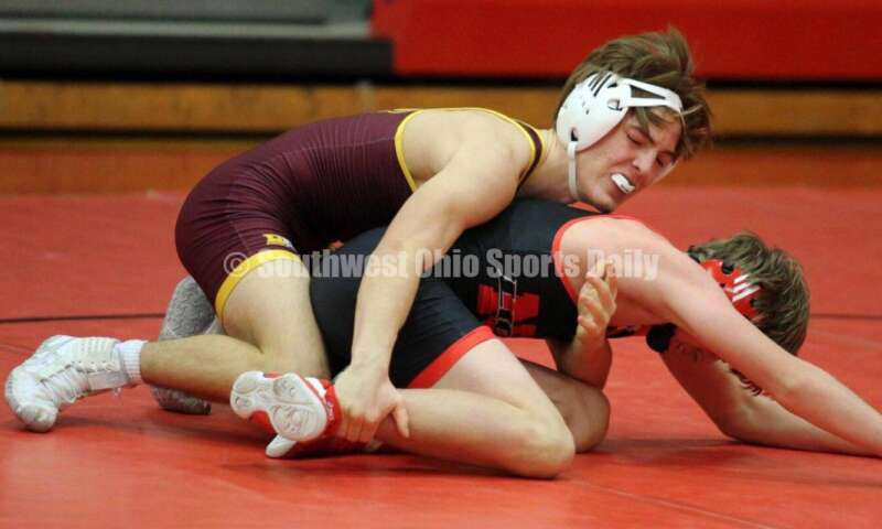 Ross High School's Ryan Foster (left) is on top of New Richmond's Derrick Klinker at 132 pounds Jan. 13, 2021, during a dual wrestling match at New Richmond. RICK CASSANO/STAFF