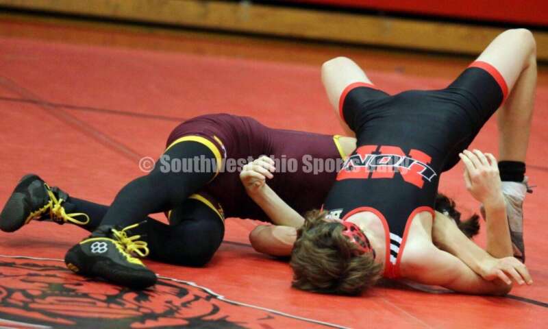 Ross High School's Jovanni Greco (left) battles New Richmond's Dillon Jacobs at 113 pounds Jan. 13, 2021, during a dual wrestling match at New Richmond. RICK CASSANO/STAFF
