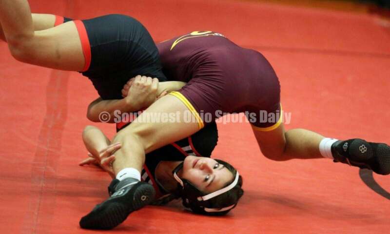 Ross High School's Jordan Miller (top) controls New Richmond's Kaitlyn Fischer at 106 pounds Jan. 13, 2021, during a dual wrestling match at New Richmond. RICK CASSANO/STAFF