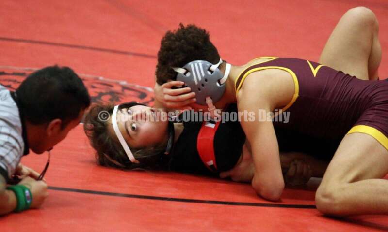 Ross High School's Jordan Miller controls New Richmond's Kaitlyn Fischer at 106 pounds Jan. 13, 2021, during a dual wrestling match at New Richmond. RICK CASSANO/STAFF