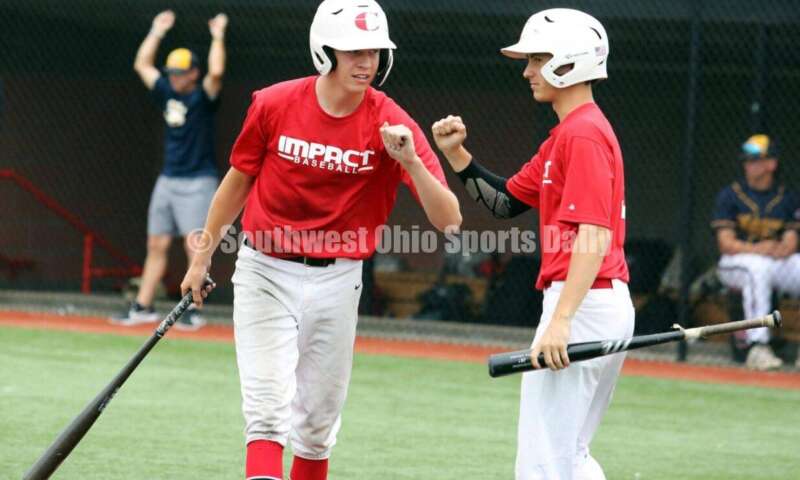 Lakota West High School's Ethan Vaught (left) and Ben Kiker (right) celebrate a run for the Cincinnati Impact on June 25, 2021, during Pastime Tournaments' Ohio Valley 17U/18U Wood Bat Classic at New Richmond. The Impact beat Sluggers Baseball Club 3-2. RICK CASSANO/STAFF