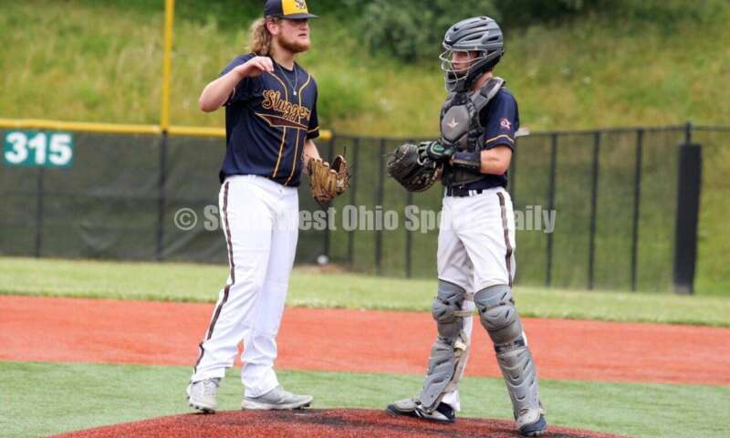 Reading High School's Chase Slusher (left) meets with Edgewood's Jesse Thompson (right) on the mound for Sluggers Baseball Club on June 25, 2021, during Pastime Tournaments' Ohio Valley 17U/18U Wood Bat Classic at New Richmond. The Sluggers lost to the Cincinnati Impact 3-2. RICK CASSANO/STAFF