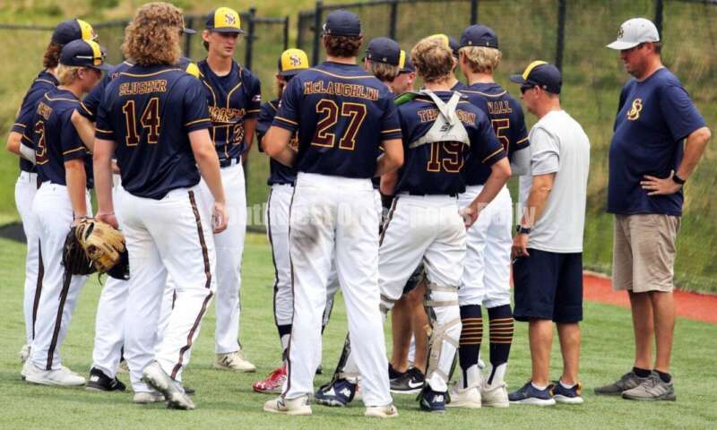 Sluggers Baseball Club players and coaches meet between innings June 25, 2021, during Pastime Tournaments' Ohio Valley 17U/18U Wood Bat Classic at New Richmond. The Sluggers lost to the Cincinnati Impact 3-2. RICK CASSANO/STAFF