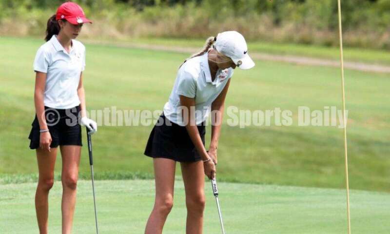 Fenwick High School's Kaitlyn Hemmelgarn sinks a putt as teammate Sophie Rush watches Aug. 6, 2021, during a Greater Catholic League Coed Division girls golf match against Dayton Carroll at Brown's Run Country Club. Fenwick won 172-188. RICK CASSANO/STAFF