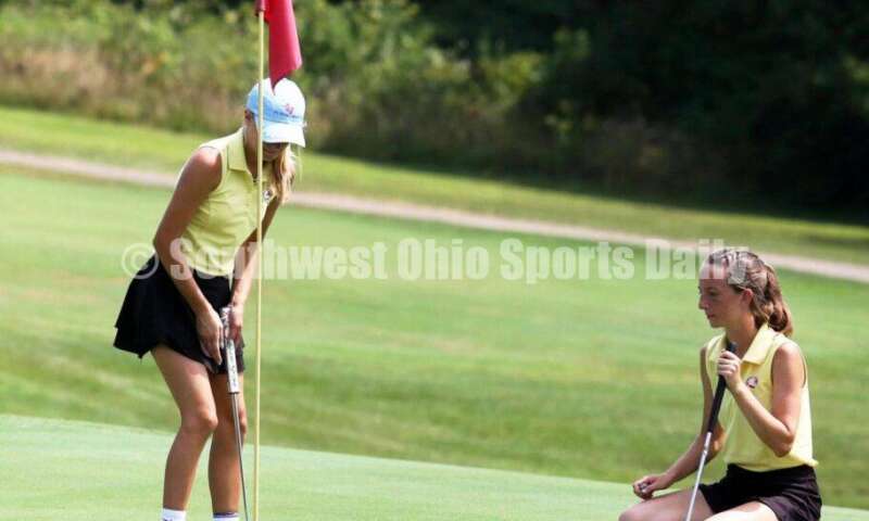 Fenwick High School's Amelia Snyder (right) watches teammate Jocelyn Wright putt Aug. 6, 2021, during a Greater Catholic League Coed Division girls golf match against Dayton Carroll at Brown's Run Country Club. Fenwick won 172-188. RICK CASSANO/STAFF