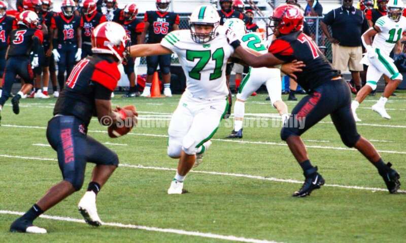 Badin High School's Logan Neu (71) charges toward Mount Healthy's Troy Montgomery (11) on Aug. 20, 2021, during a nonleague football game at Mount Healthy. Badin won 27-7. CONTRIBUTED PHOTO BY JON SEPCHINSKI