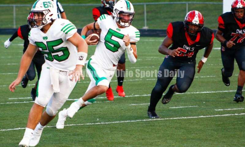 Badin High School quarterback Landyn Vidourek gets some blocking help from Kyle Stevenson (65) en route to a touchdown Aug. 20, 2021, during a nonleague football contest at Mount Healthy. Badin won 27-7. CONTRIBUTED PHOTO BY JON SEPCHINSKI