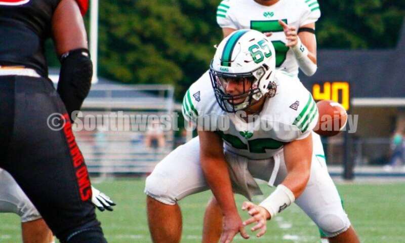 Badin High School quarterback Landyn Vidourek takes a snap from Kyle Stevenson on Aug. 20, 2021, during a nonleague football clash at Mount Healthy. Badin won 27-7. CONTRIBUTED PHOTO BY JON SEPCHINSKI