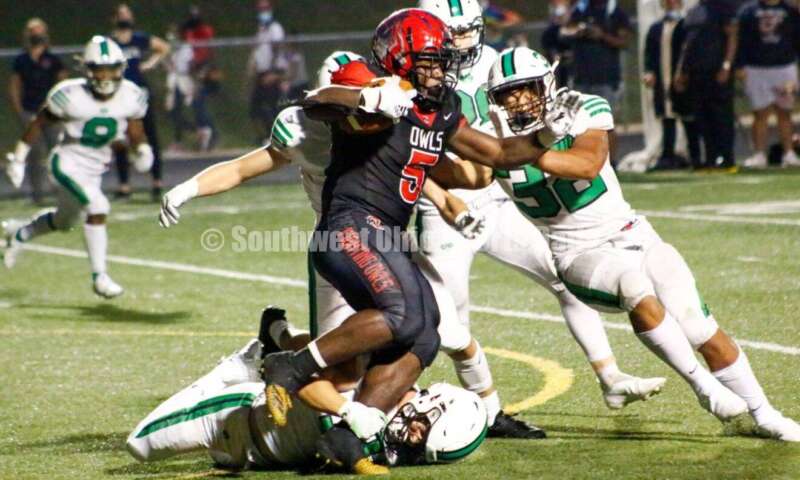 Kaden Starks (32) is among the Badin High School defenders trying to bring down Mount Healthy's Isaiah Daniels on Aug. 20, 2021, during a nonleague football clash at Mount Healthy. Badin won 27-7. CONTRIBUTED PHOTO BY JON SEPCHINSKI