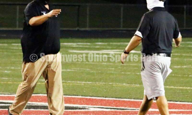 Badin High School coach Nick Yordy (right) greets Arvie Crouch, his Mount Healthy counterpart, after Badin's 27-7 nonleague football win Aug. 20, 2021, at Mount Healthy. CONTRIBUTED PHOTO BY JON SEPCHINSKI