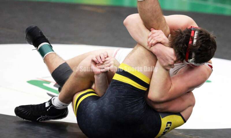 Fairfield High School's Lane Abrams (top) battles Centerville's Aydan George in a 165-pound match Dec. 19, 2021, during the Southwest Ohio Wrestling Coaches Association Coaches Classic at Harrison High School. RICK CASSANO/STAFF