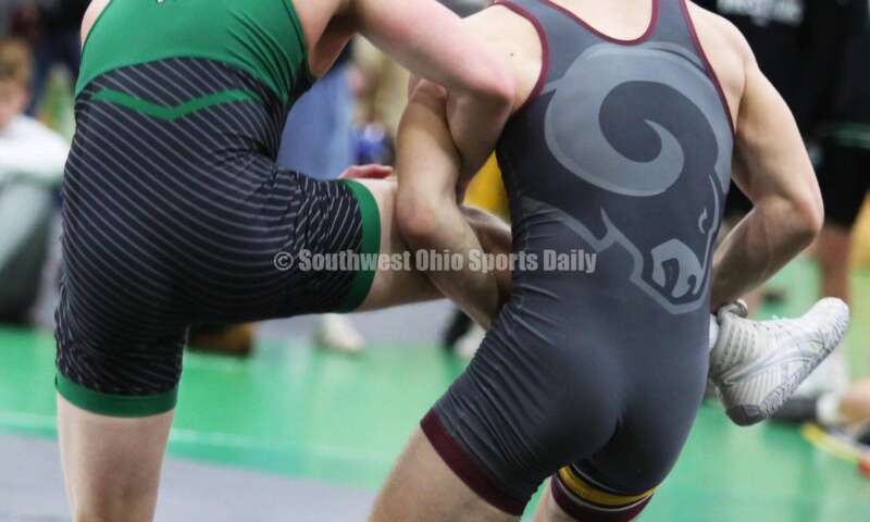 Ross High School's Ryan Foster grabs the leg of Harrison's Maddox Carter in a 138-pound match Dec. 19, 2021, during the Southwest Ohio Wrestling Coaches Association Coaches Classic at Harrison High School. RICK CASSANO/STAFF
