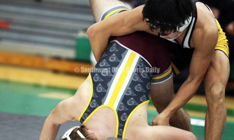 Centerville High School's Spencer Meng flips Ryan Foster of Ross in a 138-pound match Dec. 19, 2021, during the Southwest Ohio Wrestling Coaches Association Coaches Classic at Harrison High School. RICK CASSANO/STAFF
