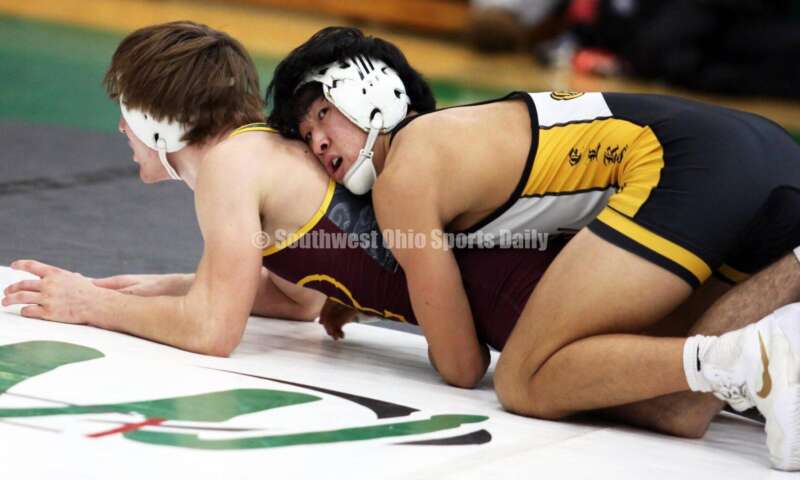Centerville High School's Spencer Meng (right) grabs Ryan Foster of Ross in a 138-pound match Dec. 19, 2021, during the Southwest Ohio Wrestling Coaches Association Coaches Classic at Harrison High School. RICK CASSANO/STAFF