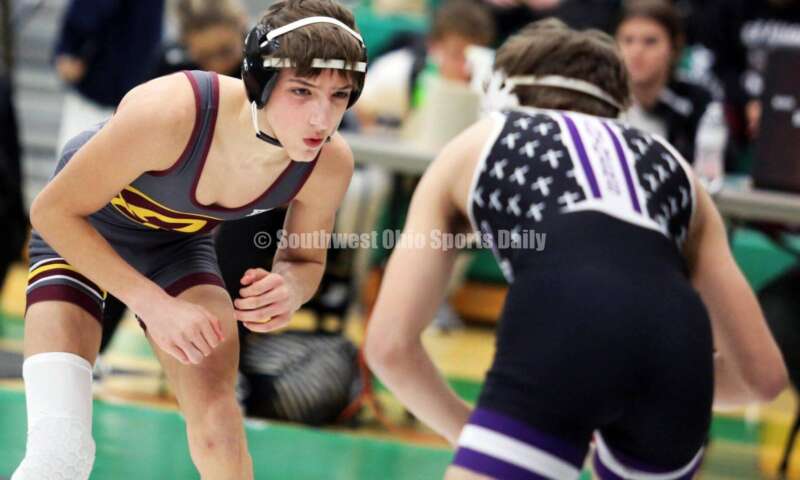 Ross High School's Jovanni Greco (left) eyes Elder's Joey Thamann in a 113-pound match Dec. 19, 2021, during the Southwest Ohio Wrestling Coaches Association Coaches Classic at Harrison High School. RICK CASSANO/STAFF