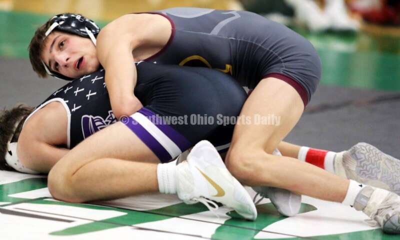 Ross High School's Jovanni Greco (top) competes with Elder's Joey Thamann in a 113-pound match Dec. 19, 2021, during the Southwest Ohio Wrestling Coaches Association Coaches Classic at Harrison High School. RICK CASSANO/STAFF