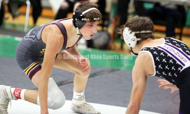 Ross High School's Jovanni Greco (left) eyes Elder's Joey Thamann in a 113-pound match Dec. 19, 2021, during the Southwest Ohio Wrestling Coaches Association Coaches Classic at Harrison High School. RICK CASSANO/STAFF