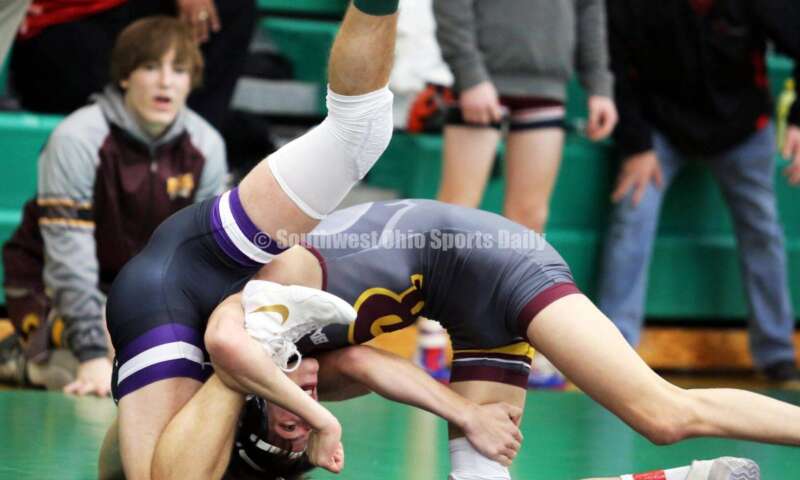 Ross High School's Jovanni Greco (right) competes with Elder's Joey Thamann in a 113-pound match Dec. 19, 2021, during the Southwest Ohio Wrestling Coaches Association Coaches Classic at Harrison High School. RICK CASSANO/STAFF