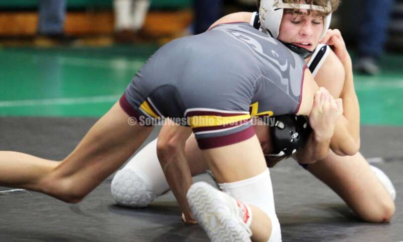 Ross High School's Jovanni Greco (front) competes with Elder's Joey Thamann in a 113-pound match Dec. 19, 2021, during the Southwest Ohio Wrestling Coaches Association Coaches Classic at Harrison High School. RICK CASSANO/STAFF