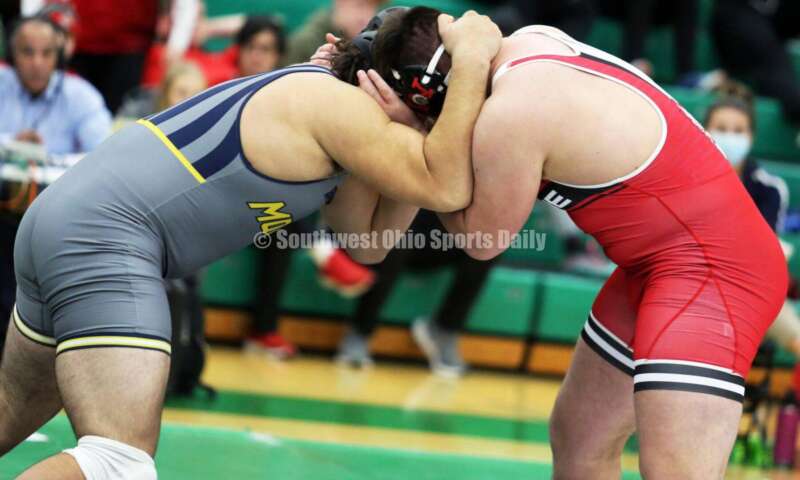 Monroe High School's Chris Reber (left) and Huber Heights Wayne's Joshua Padilla compete in the 285-pound championship match Dec. 19, 2021, during the Southwest Ohio Wrestling Coaches Association Coaches Classic at Harrison High School. RICK CASSANO/STAFF