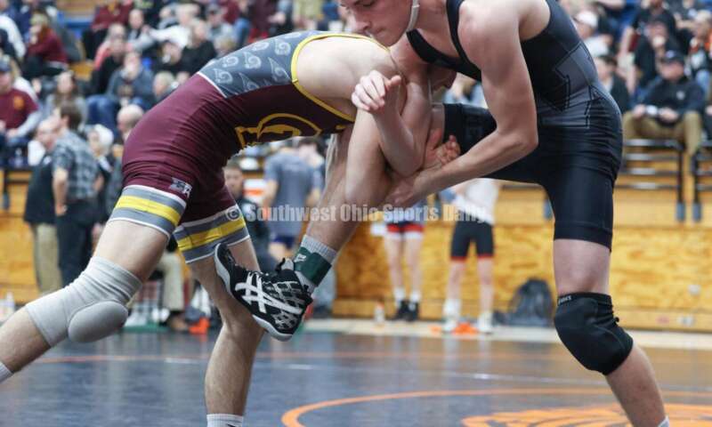 Ross High School's Ryan Foster (left) battles Wilmington's Carson Hibbs during the 132-pound third-place match at the Division II district wrestling tournament March 5, 2022, in Wilmington. RON ALVEY/CONTRIBUTOR