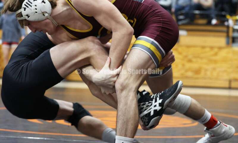 Ross High School's Ryan Foster (right) controls Wilmington's Carson Hibbs during the 132-pound third-place match at the Division II district wrestling tournament March 5, 2022, in Wilmington. RON ALVEY/CONTRIBUTOR