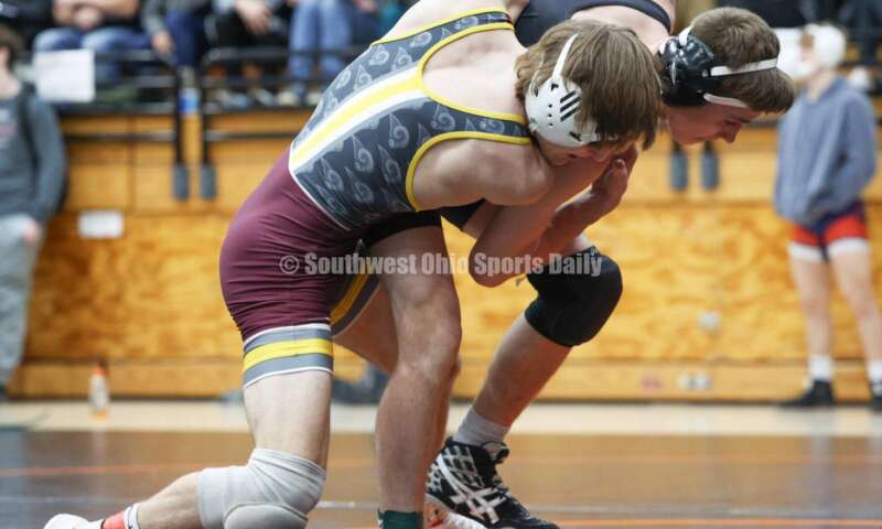 Ross High School's Ryan Foster (left) grabs Wilmington's Carson Hibbs during the 132-pound third-place match at the Division II district wrestling tournament March 5, 2022, in Wilmington. RON ALVEY/CONTRIBUTOR