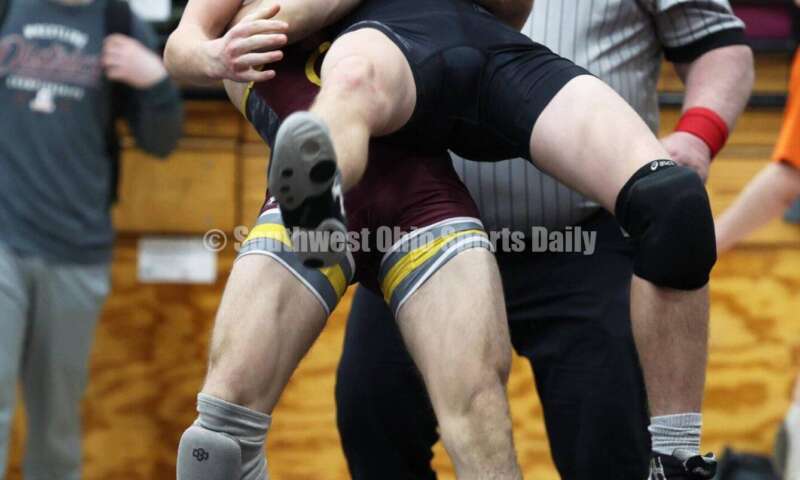 Ross High School's Ryan Foster picks up Wilmington's Carson Hibbs during the 132-pound third-place match at the Division II district wrestling tournament March 5, 2022, in Wilmington. RON ALVEY/CONTRIBUTOR