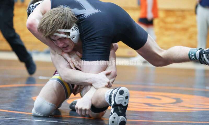 Ross High School's Ryan Foster gets under Wilmington's Carson Hibbs during the 132-pound third-place match at the Division II district wrestling tournament March 5, 2022, in Wilmington. RON ALVEY/CONTRIBUTOR