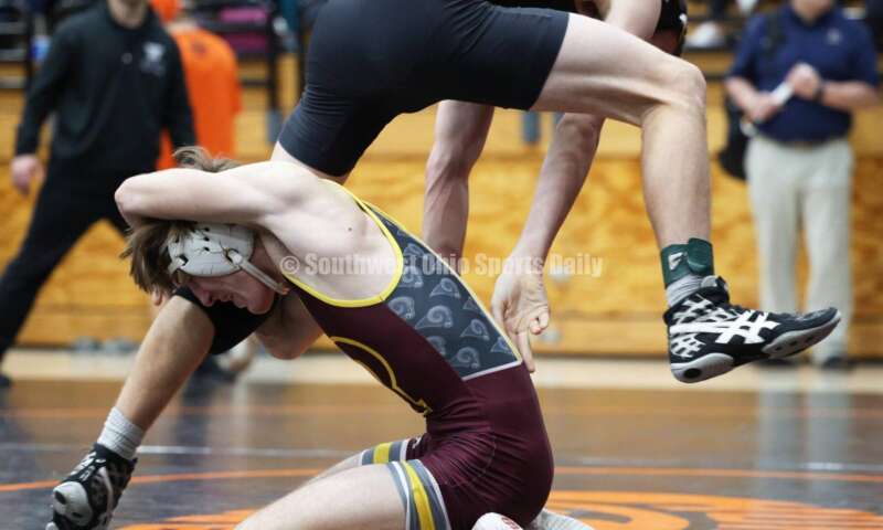 Ross High School's Ryan Foster grabs the leg of Wilmington's Carson Hibbs during the 132-pound third-place match at the Division II district wrestling tournament March 5, 2022, in Wilmington. RON ALVEY/CONTRIBUTOR