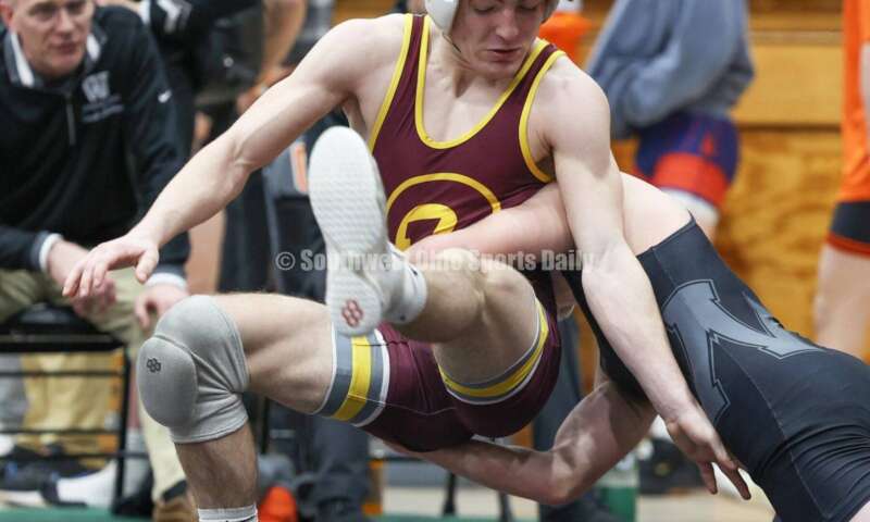 Ross High School's Ryan Foster (left) battles Wilmington's Carson Hibbs in the 132-pound third-place match at the Division II district wrestling tournament March 5, 2022, in Wilmington. RON ALVEY/CONTRIBUTOR