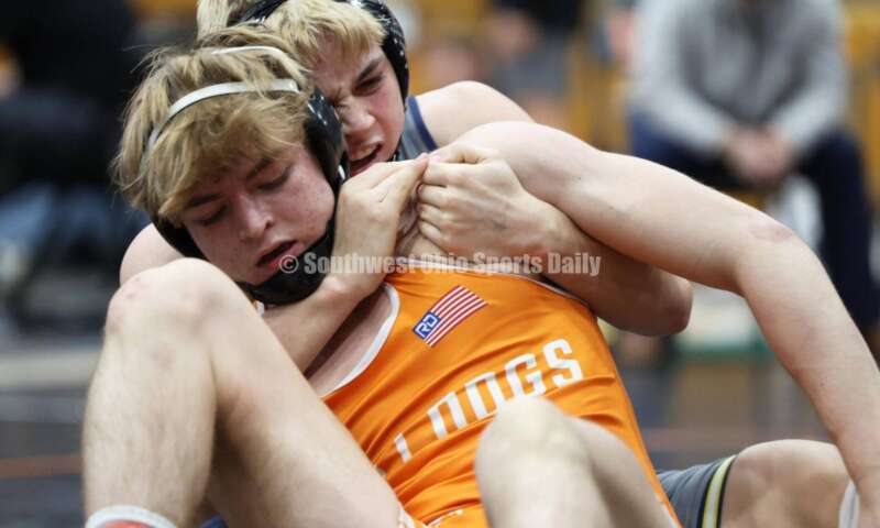 Monroe High School's Alex Pitsch (behind) gets a grip on Heath's Riley Gould in the 150-pound third-place match at the Division II district wrestling tournament March 5, 2022, in Wilmington. RON ALVEY/CONTRIBUTOR