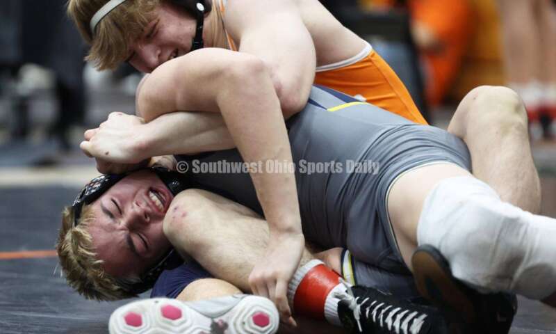 Monroe High School's Alex Pitsch (front) wrestles Heath's Riley Gould in the 150-pound third-place match at the Division II district wrestling tournament March 5, 2022, in Wilmington. RON ALVEY/CONTRIBUTOR