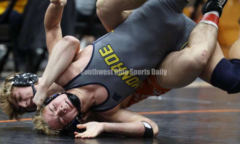 Monroe High School's Alex Pitsch (front) competes with Heath's Riley Gould in the 150-pound third-place match at the Division II district wrestling tournament March 5, 2022, in Wilmington. RON ALVEY/CONTRIBUTOR