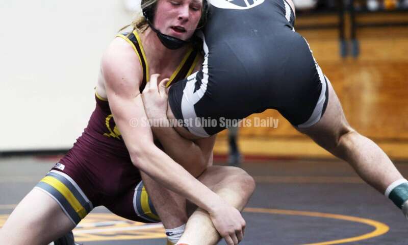 Ross High School's Ryan Iams (left) battles St. Paris Graham's Zack Burroughs in the 175-pound championship match at the Division II district wrestling tournament March 5, 2022, in Wilmington. RON ALVEY/CONTRIBUTOR