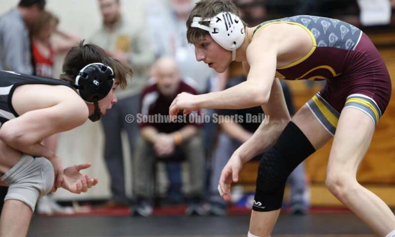 Ross High School's Jovanni Greco (right) eyes St. Paris Graham's Brogan Tucker during the 113-pound championship match at the Division II district wrestling tournament March 5, 2022, in Wilmington. RON ALVEY/CONTRIBUTOR