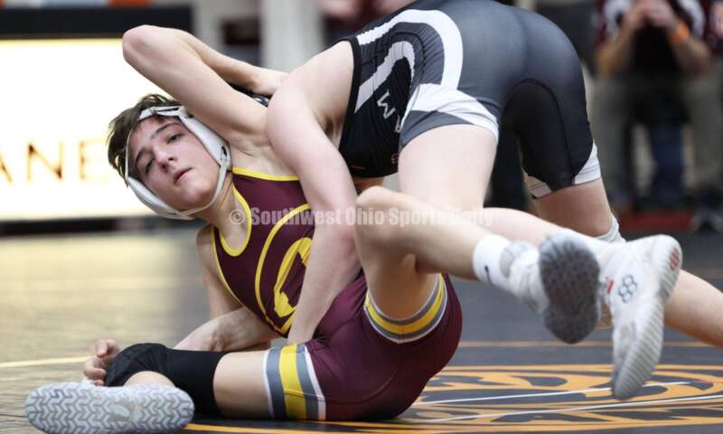Ross High School's Jovanni Greco (left) competes with St. Paris Graham's Brogan Tucker during the 113-pound championship match at the Division II district wrestling tournament March 5, 2022, in Wilmington. RON ALVEY/CONTRIBUTOR