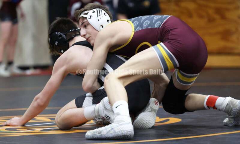 Ross High School's Jovanni Greco grabs St. Paris Graham's Brogan Tucker during the 113-pound championship match at the Division II district wrestling tournament March 5, 2022, in Wilmington. RON ALVEY/CONTRIBUTOR