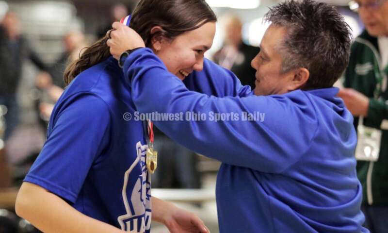 Hamilton High School athletic director Missy Harvey gives Lilly Arvin her championship medal March 12, 2022, after the Division I state girls bowling tournament at Wayne Webb's Columbus Bowl. RICK CASSANO/STAFF